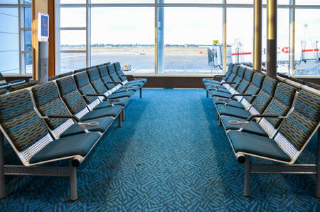 POV to empty long bench chair in airport