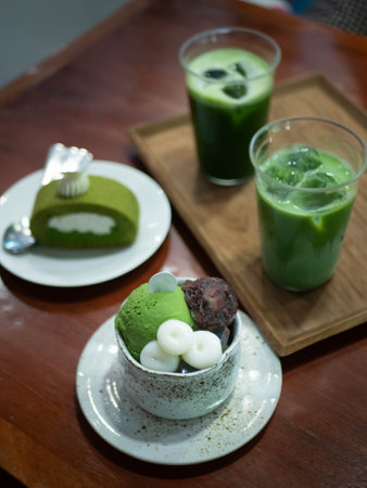parfait,matcha green tea roll sweet japanese dessert with green tea milk matcha on wooden table in minimal japanese style cafeの写真素材