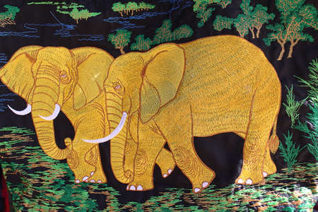 embroidery golden elephants on clothの写真素材