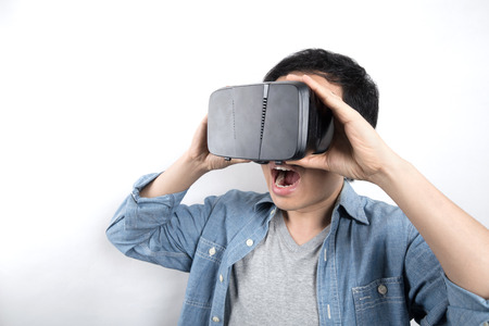 Asian man use VR glasses watching videoの写真素材