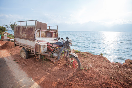 Broken motorcycle beside the seaの写真素材