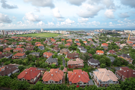 houses under the cloudy skyの写真素材