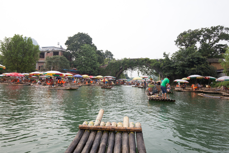 Yangshuo,china - july,15,2015:peoples traveling on the bamboo boat in yangshuo china.のeditorial素材