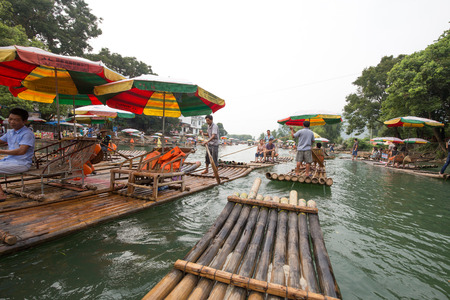 Yangshuo,china - july,15,2015:peoples traveling on the bamboo boat in yangshuo china.のeditorial素材
