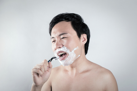 Asian man is shavingの写真素材
