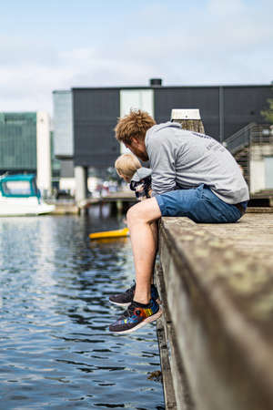 Kid exploring modern living area by the waterの写真素材