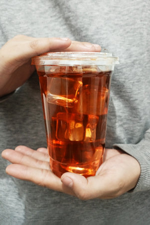 Coffee cup in hand front viewの写真素材