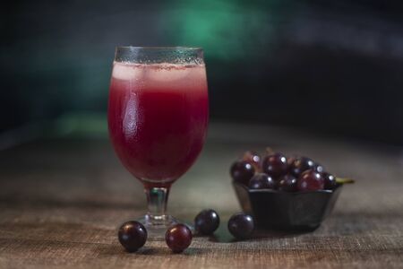 Fresh grape juice on Dark background with fresh grapeの写真素材