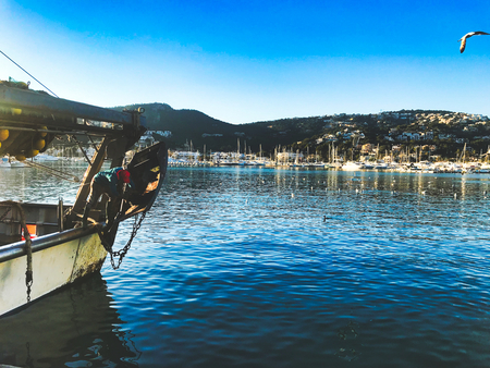 man works after a long day from fishing and clean the ship in port andraitx in mallorcaの写真素材