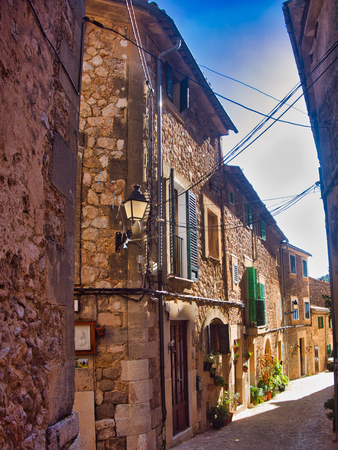 beauty small village in mallorca, called Valldemosa, nice flowers, red bike and cute buildings.の写真素材