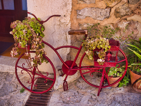 beauty small village in mallorca, called Valldemosa, nice flowers, red bike and cute buildings.の写真素材