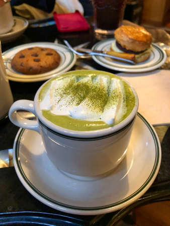 cup of matcha latte tea with biscuitsの写真素材