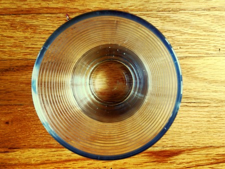 Top view of a drinking glass on a wood tableの写真素材
