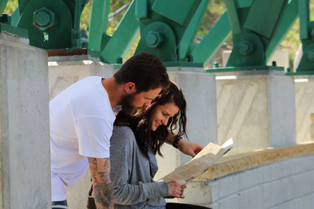 Young couple looking at travel map のeditorial素材