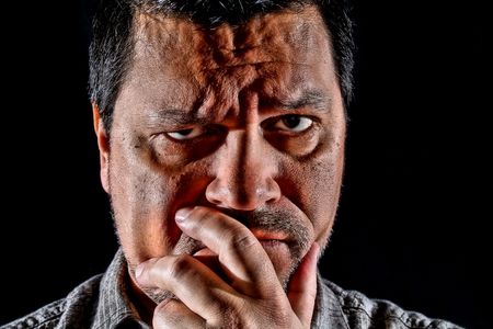 Close up headshot of man in deep thought.の写真素材