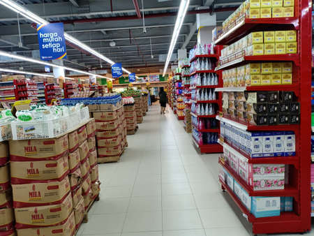 Manado, Indonesia - February 18th 2020; clean tile floor with various products for sale arranged in between supermaket aisle.のeditorial素材