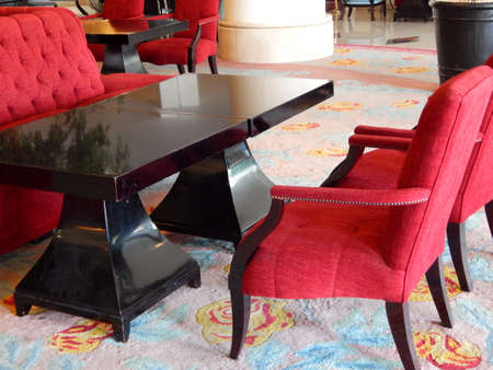 Manado, Indonesia - March 23rd, 2015; Red sofa, chairs and black table in the lobby of Arya Duta hotelのeditorial素材