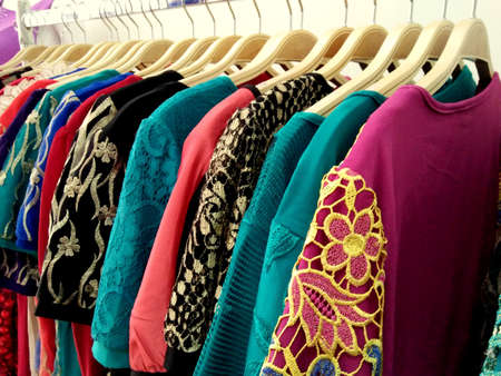 Manado, Indonesia, -December 23rd, 2015; Various kinds of women embroidery dress hanging on wooden hangers in the fashion storeのeditorial素材