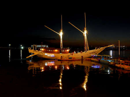 Makassar, Indonesia-26th September 2017; A white phinisi sailing boat is anchored at the marina in...
