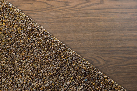 Coffee beans diagonal on one side - wooden backgroundの写真素材