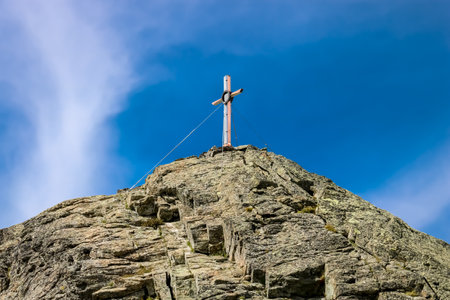 A wooden summit cross on the top of the mountainの写真素材