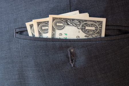 Some one dollar bills in dress pants pocketの写真素材