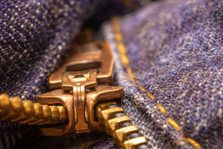 A pull tab and teeth of a zipper (denim jeans)の写真素材