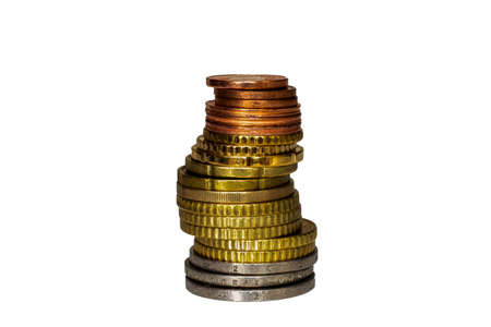 A high stack of different Euro coins on a white tableの写真素材