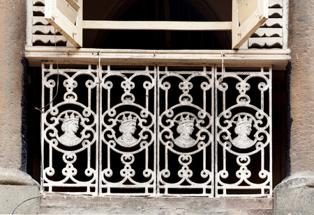 MUMBAI, INDIA â October 23 2017: Vintage cast iron railings showing effigy of Queen Victoria, on a residential building.のeditorial素材
