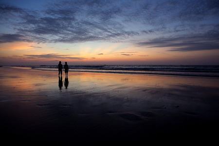 happy kids playing on beach at the sunrise timeの写真素材
