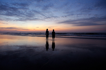 happy kids playing on beach at the sunrise timeの写真素材