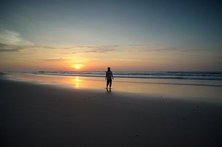 happy kids playing on beach at the sunrise timeの写真素材