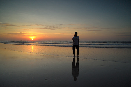 happy kids playing on beach at the sunrise timeの写真素材