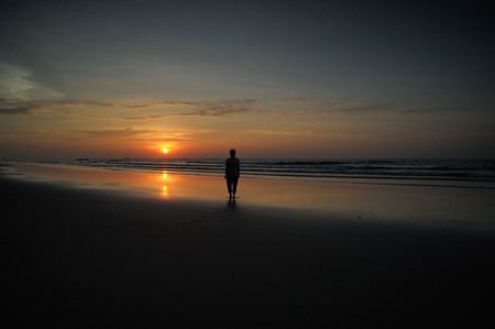 happy kids playing on beach at the sunrise timeの写真素材