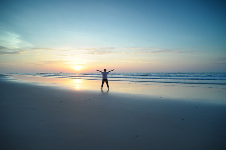 happy kids playing on beach at the sunrise timeの写真素材