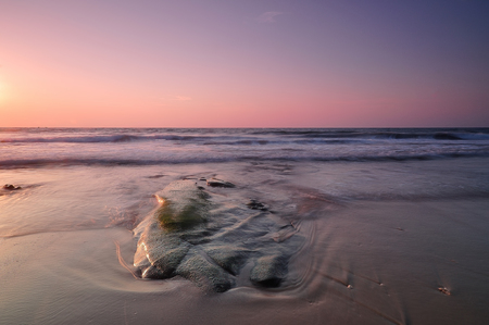 Beautiful sunset on the beach and seaの写真素材