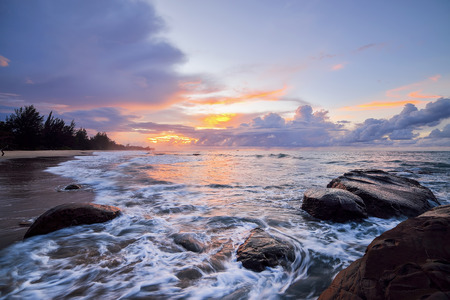 Colorful sunset on the tropical beach with beautiful sky, cloudsの写真素材