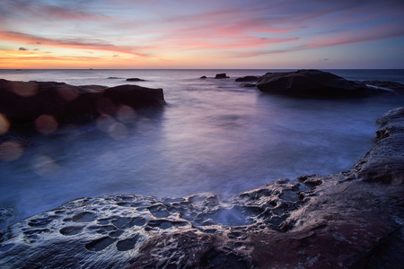 Colorful sunset on the tropical beach with beautiful sky, cloudsの写真素材