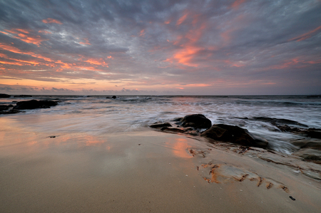 Colorful sunset on the tropical beach with beautiful sky, cloudsの写真素材