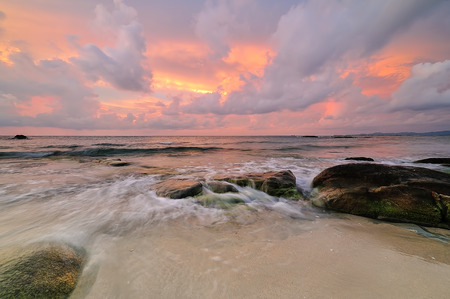 Colorful sunset on the tropical beach with beautiful sky, cloudsの写真素材