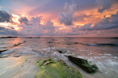 Colorful sunset on the tropical beach with beautiful sky, cloudsの写真素材