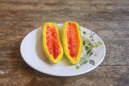 Closeup view of bitter gourd over wooden board backgroundの写真素材