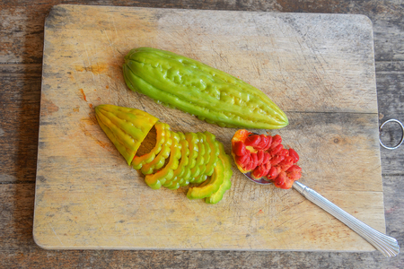 Closeup view of bitter gourd over wooden board backgroundの写真素材