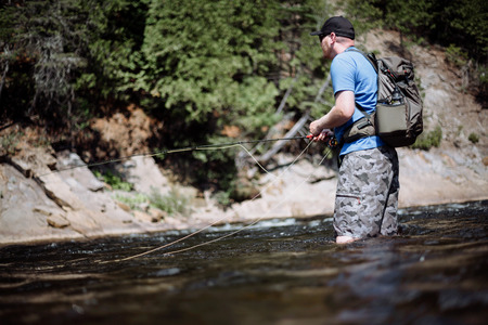 Man Fly fishing on Ste-Anne river, Quebec.の写真素材