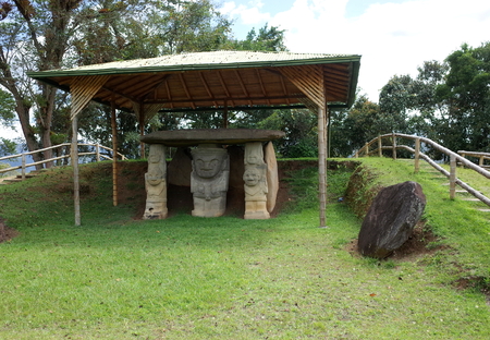 Ancient statues stand guard at a burial site at San Agustin archaeological park, Colombiaの写真素材