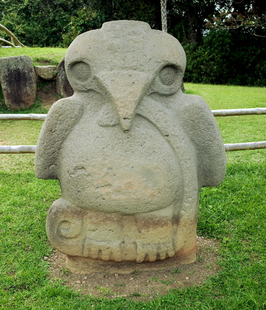 An ancient burial statue of an eagle holding a snake stands guard at San Agustin archaeological park, Colombiaの写真素材