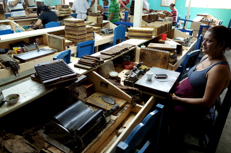 25TH AUGUST 2014, ESTELI, NICARAGUA - A woman working inside a cigar factory in Esteli, Nicaraguaのeditorial素材