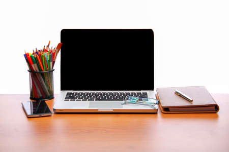 Working space. Laptop, notepad on wooden deskの写真素材