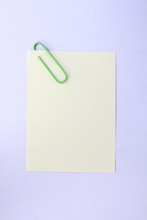 green paper clip with yellow paperの写真素材