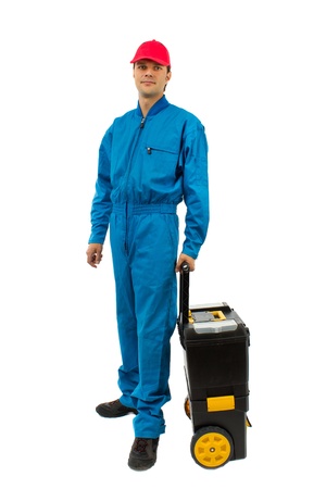 young worker wearing blue equipment tool box with wheels isolated on whiteの写真素材